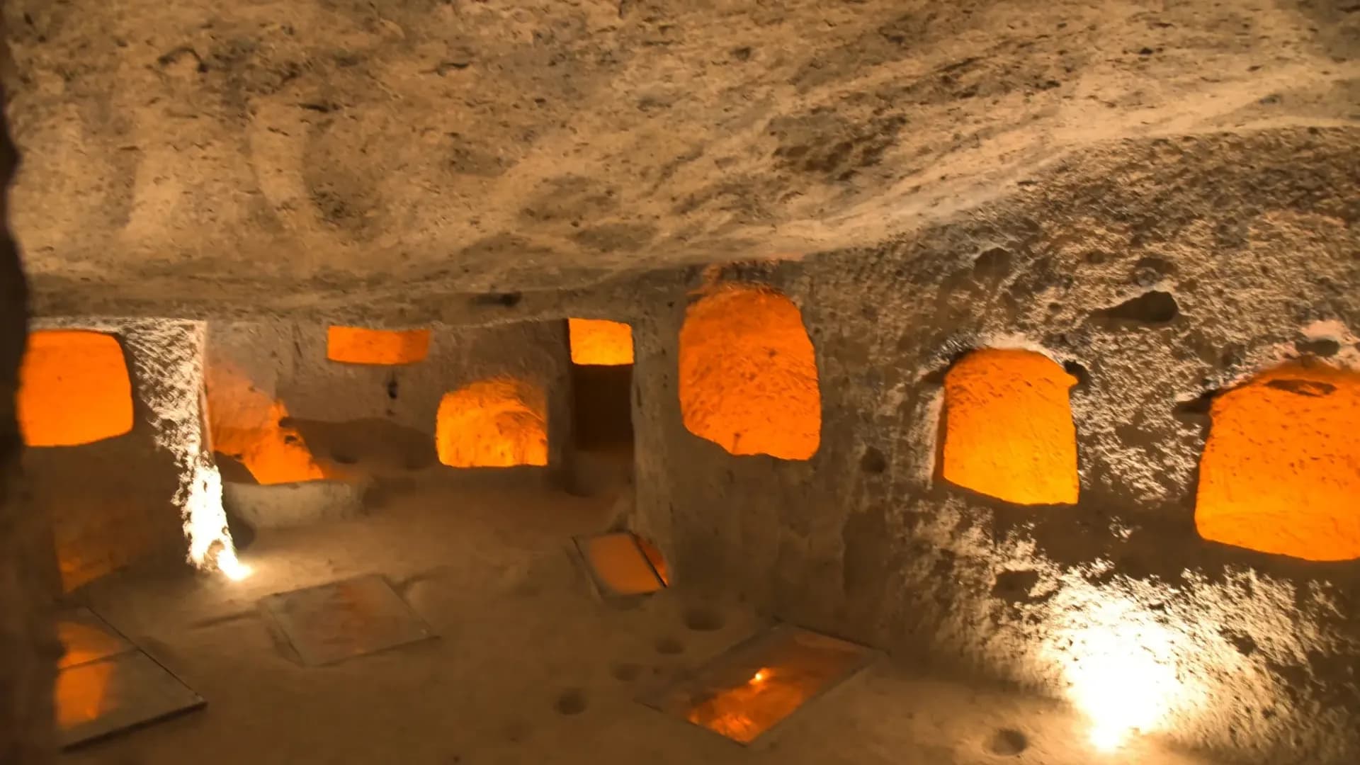 Stone arches in a softly lit underground room