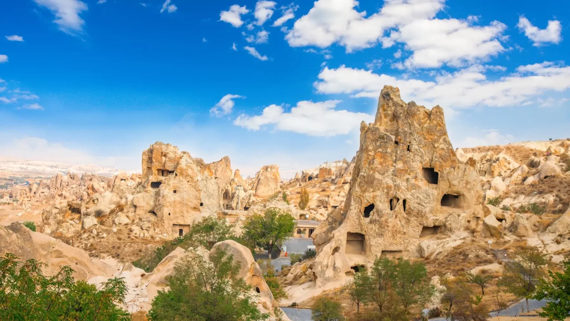 Rock-cut settlement beneath a blue sky
