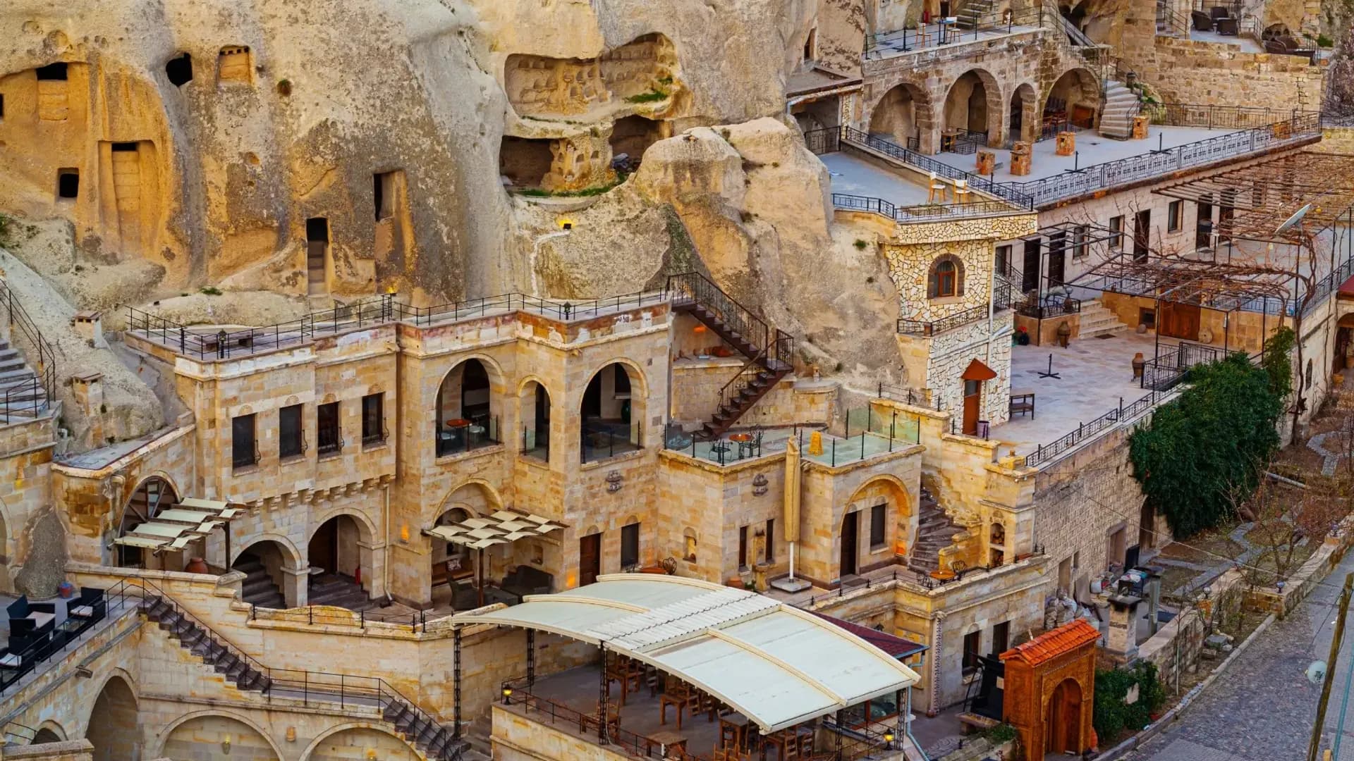 Stone buildings built into a steep rock face