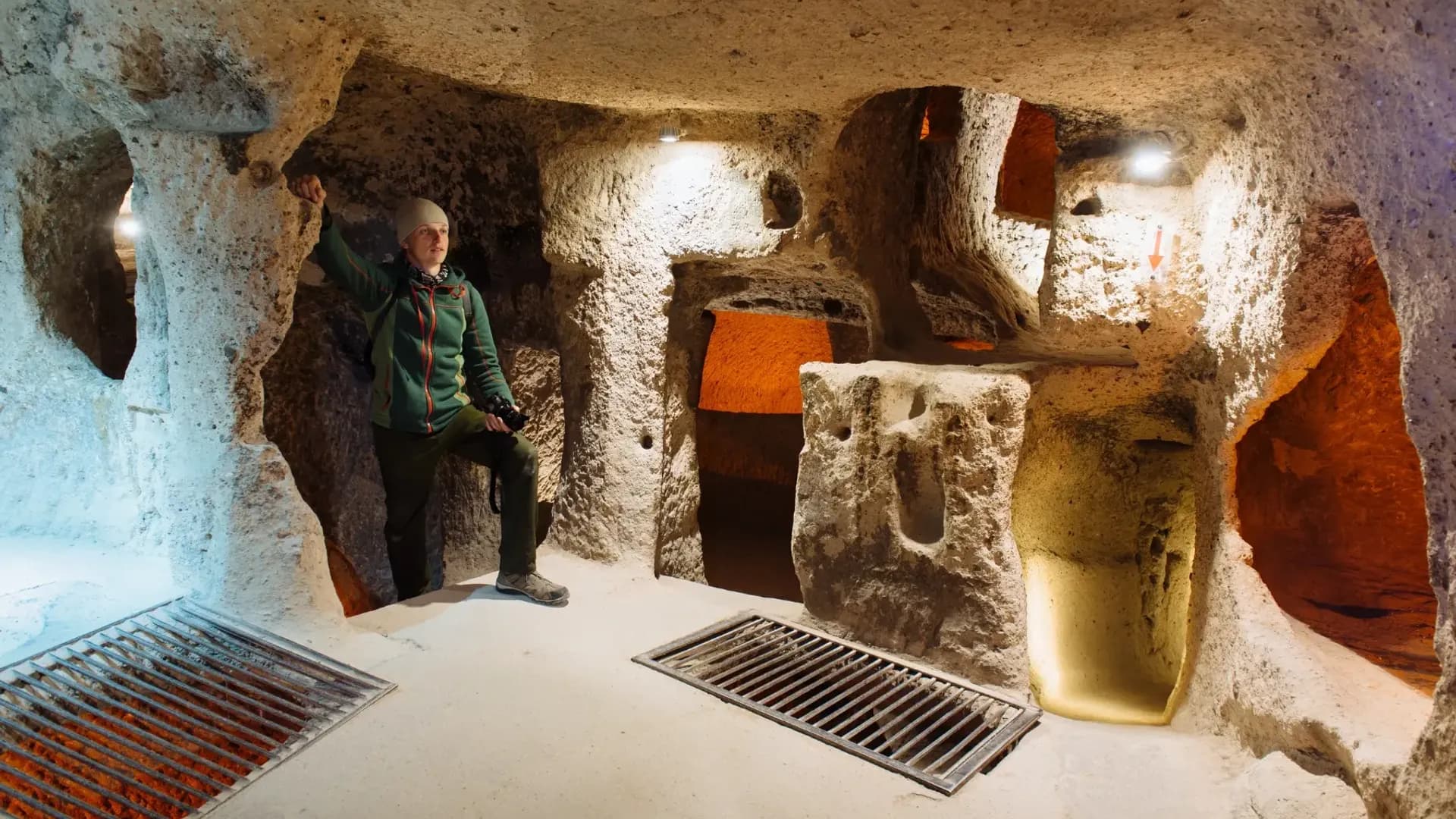 Visitor standing inside a rock-cut chamber