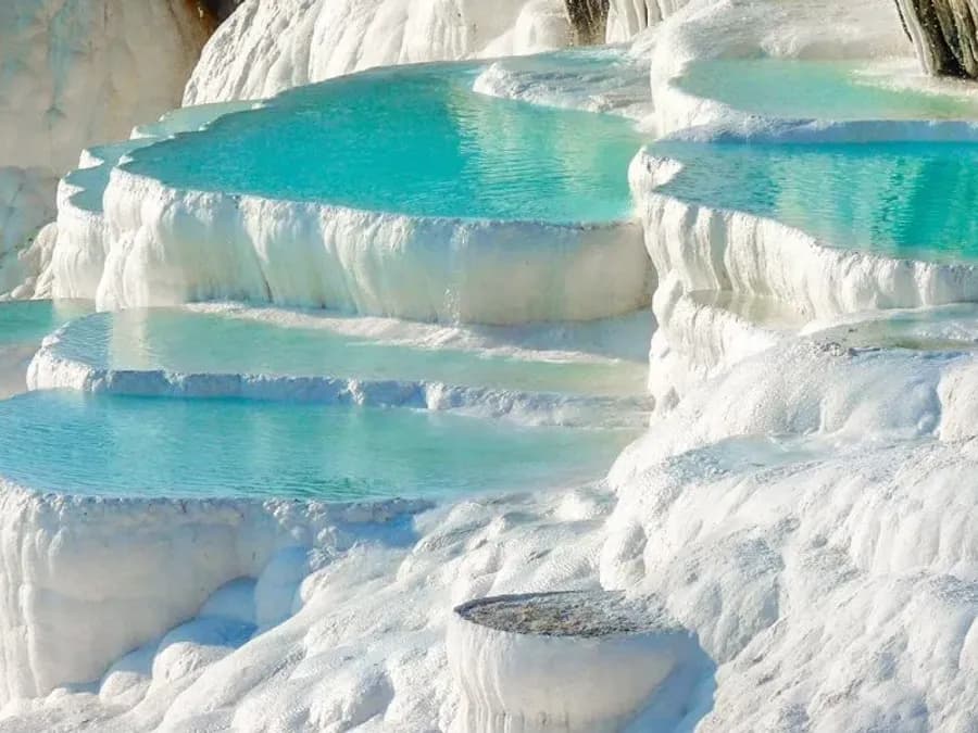 Turquoise pools on white travertine terraces