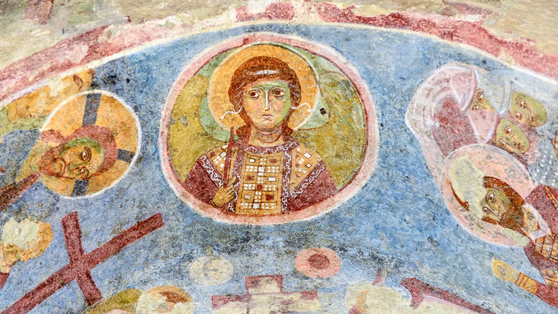 Painted religious figures on an old plaster wall