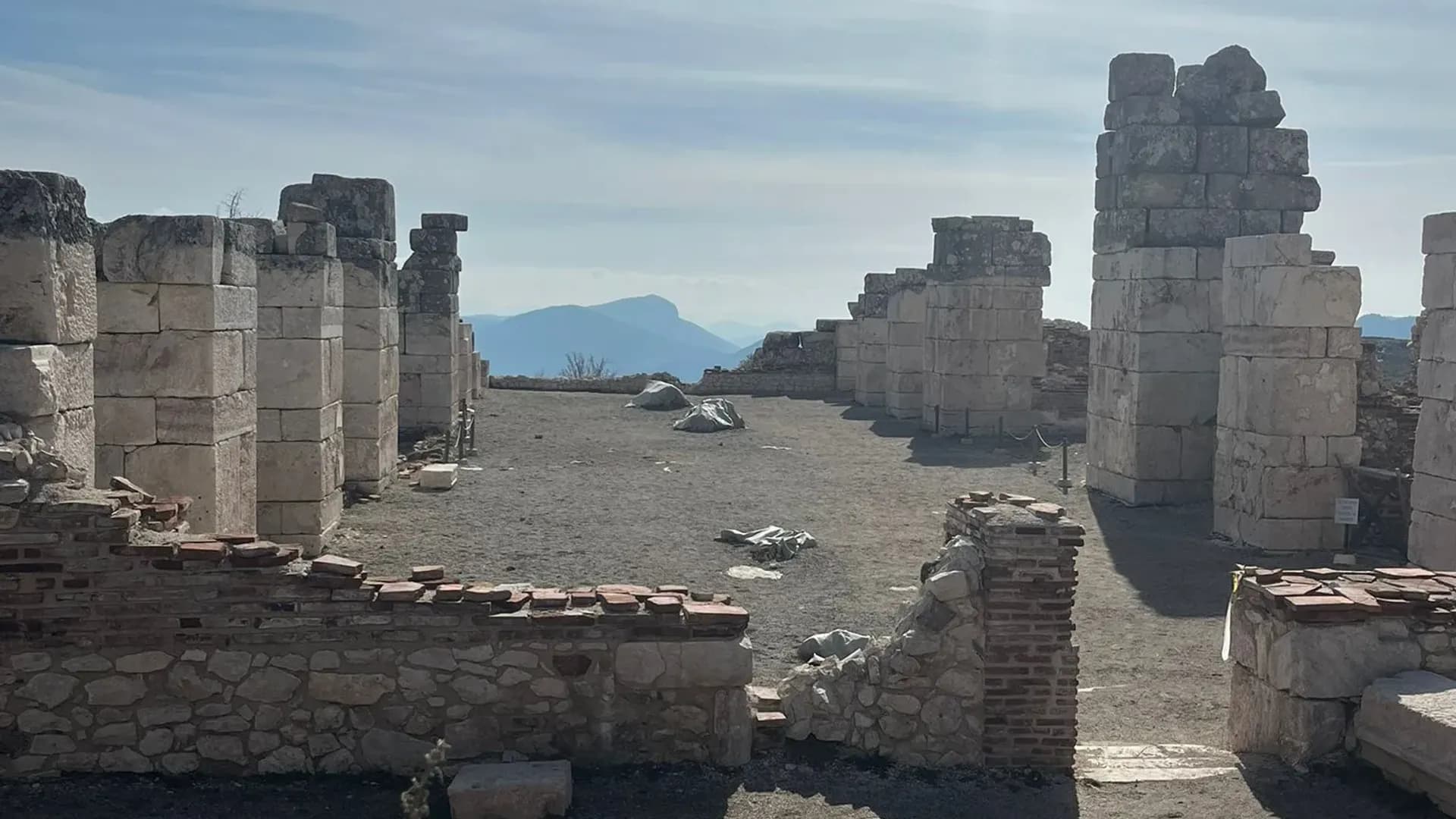 الجدران والأعمدة الحجرية القديمة تحت سماء ملبدة بالغيوم
