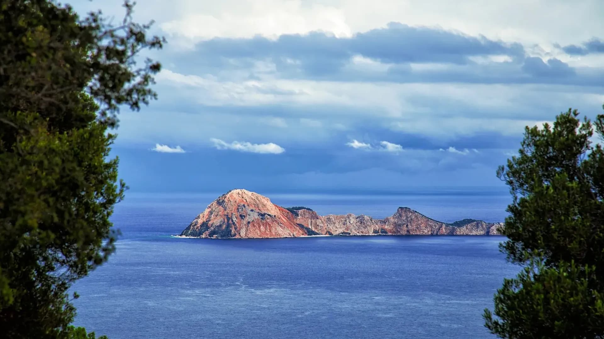 Rocky island framed by leafy trees