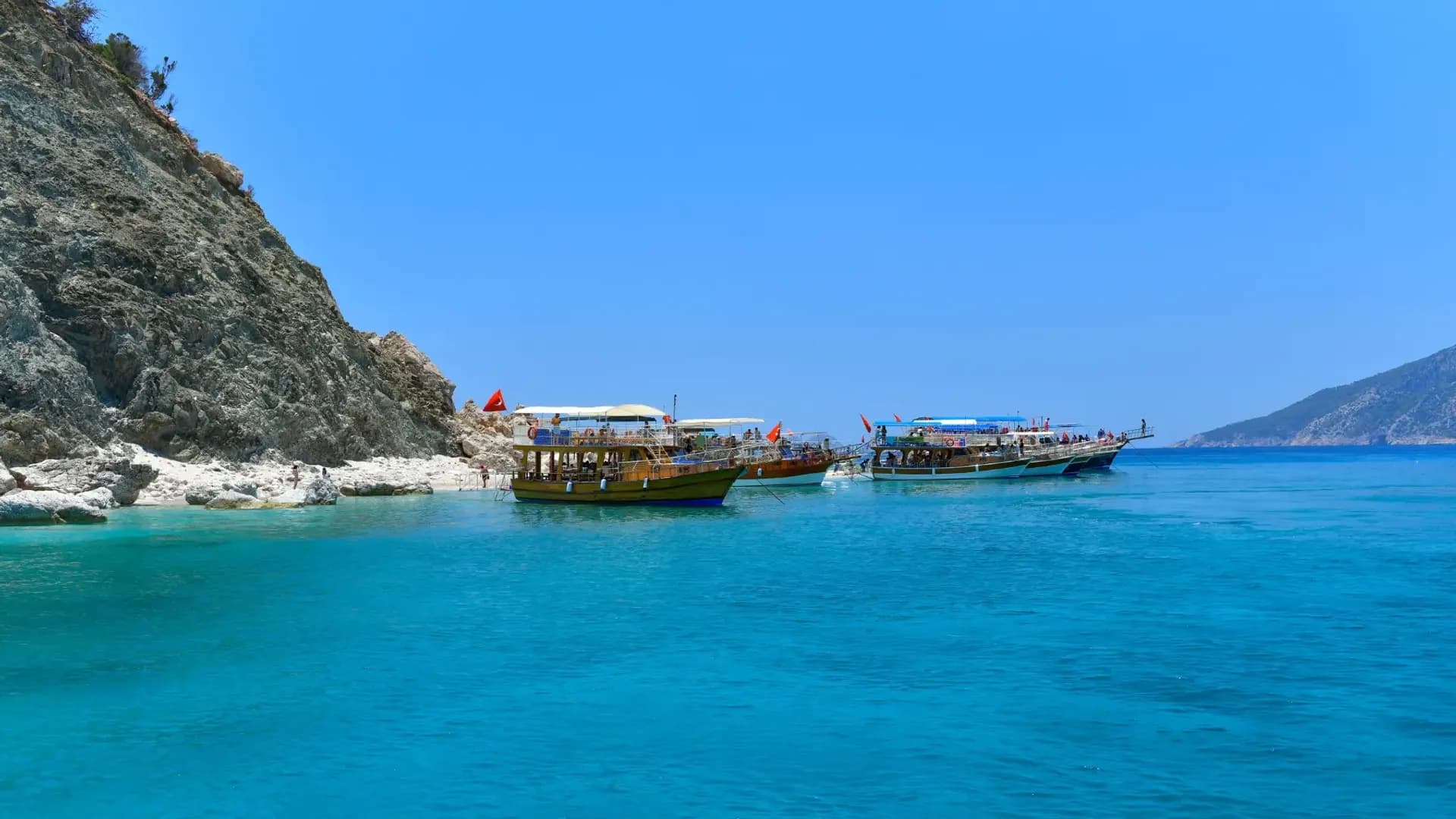 Excursion boats beside steep rocky shores