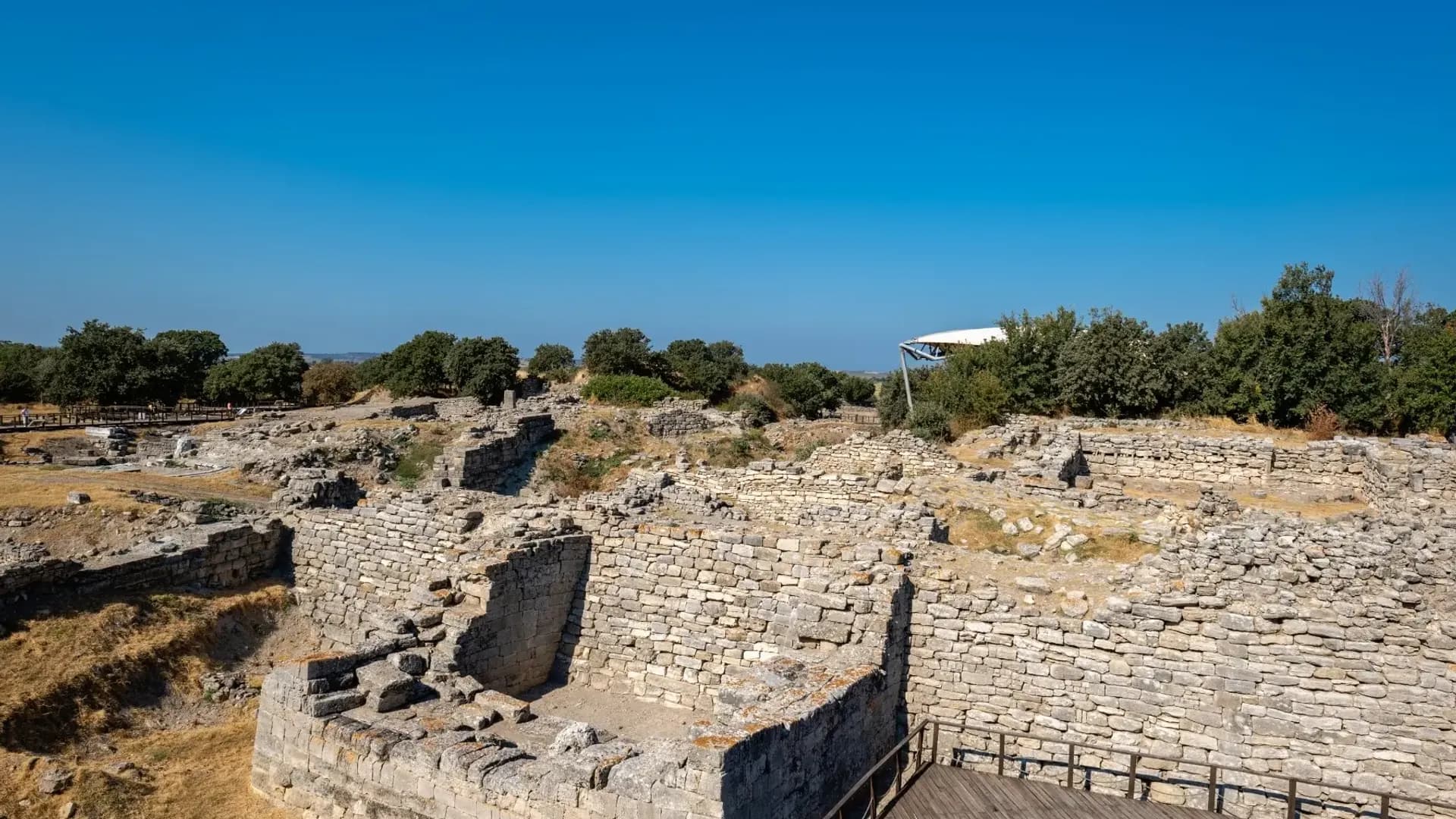 Ancient stone walls above an excavated site