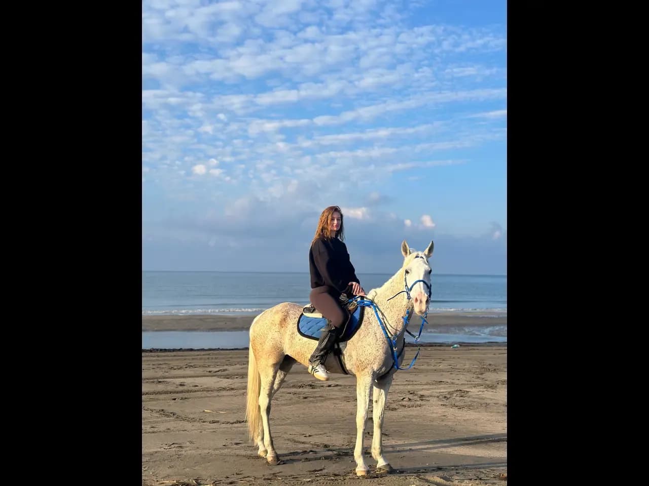 Deniz kenarında ata binen