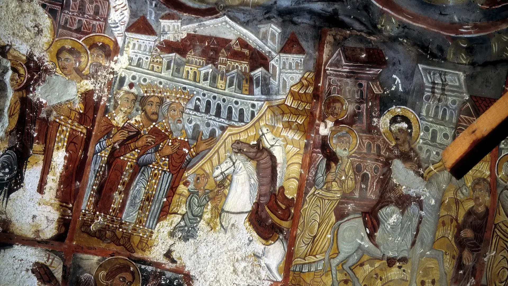 Painted figures on a rock-cut chapel wall