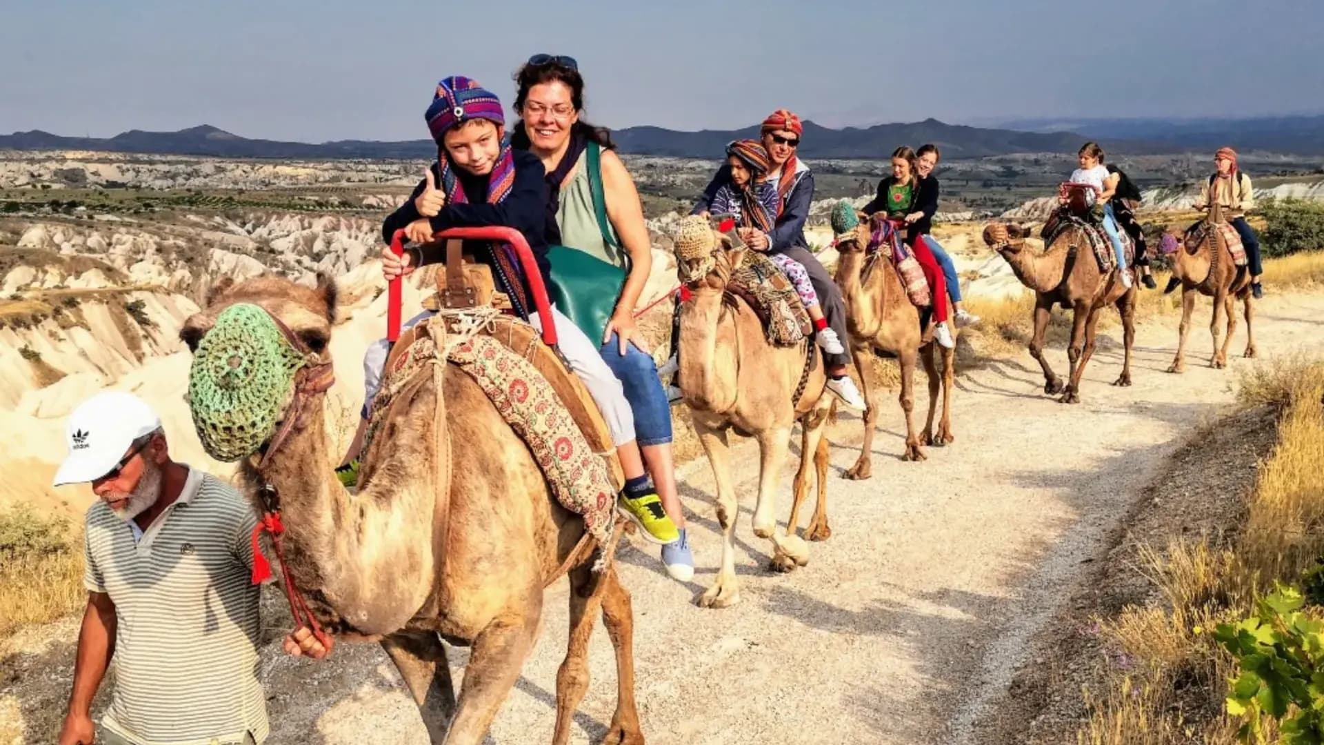 People riding camels on a path