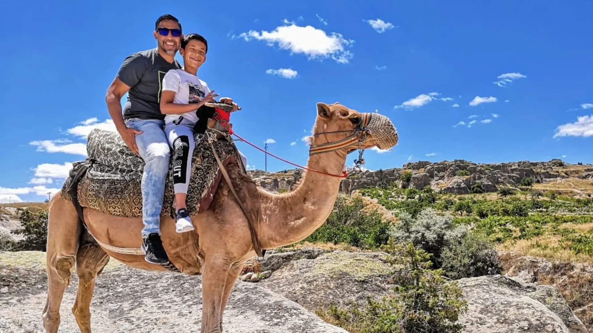 Two people riding a camel