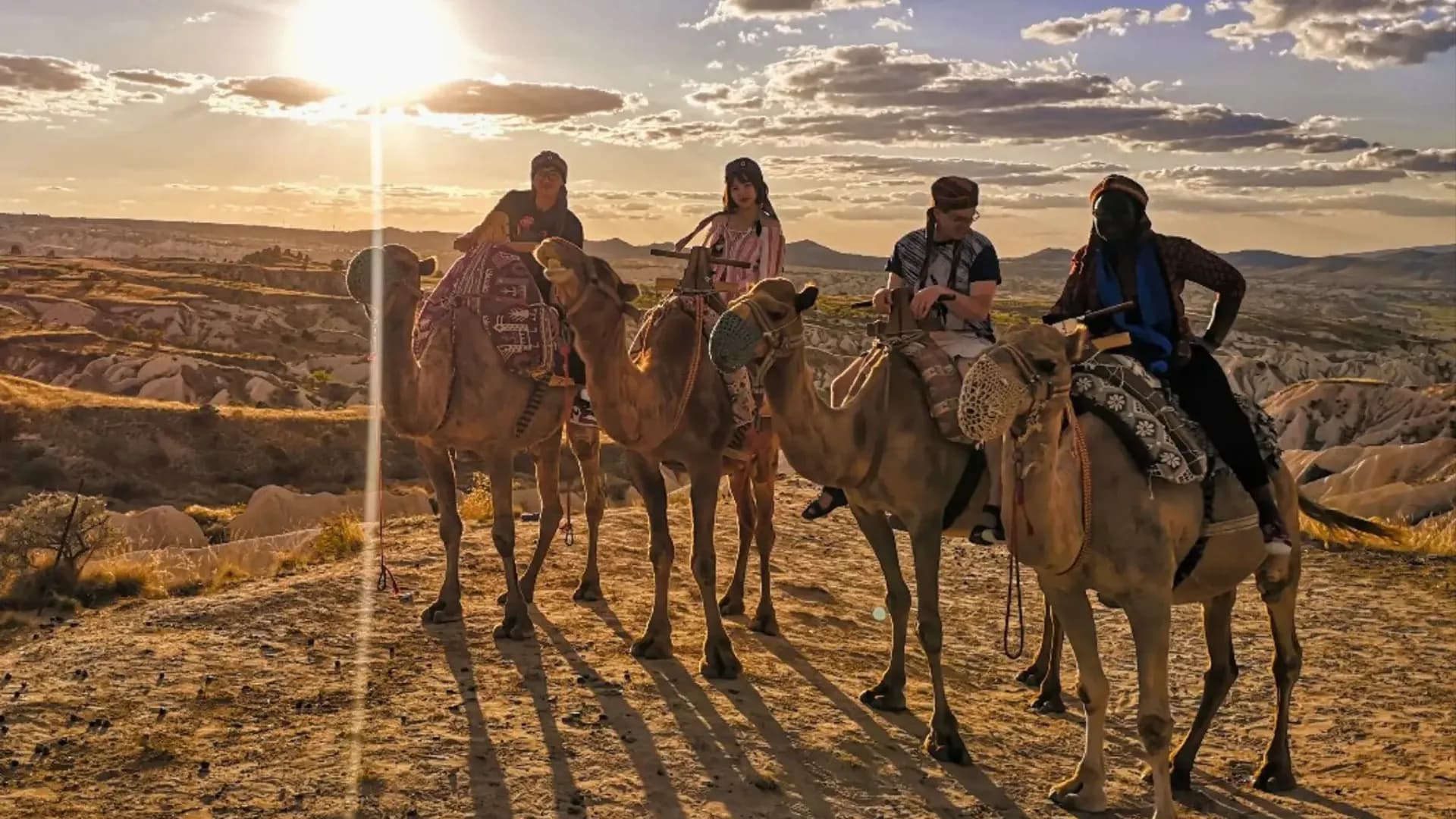 Camel riders in evening sunlight