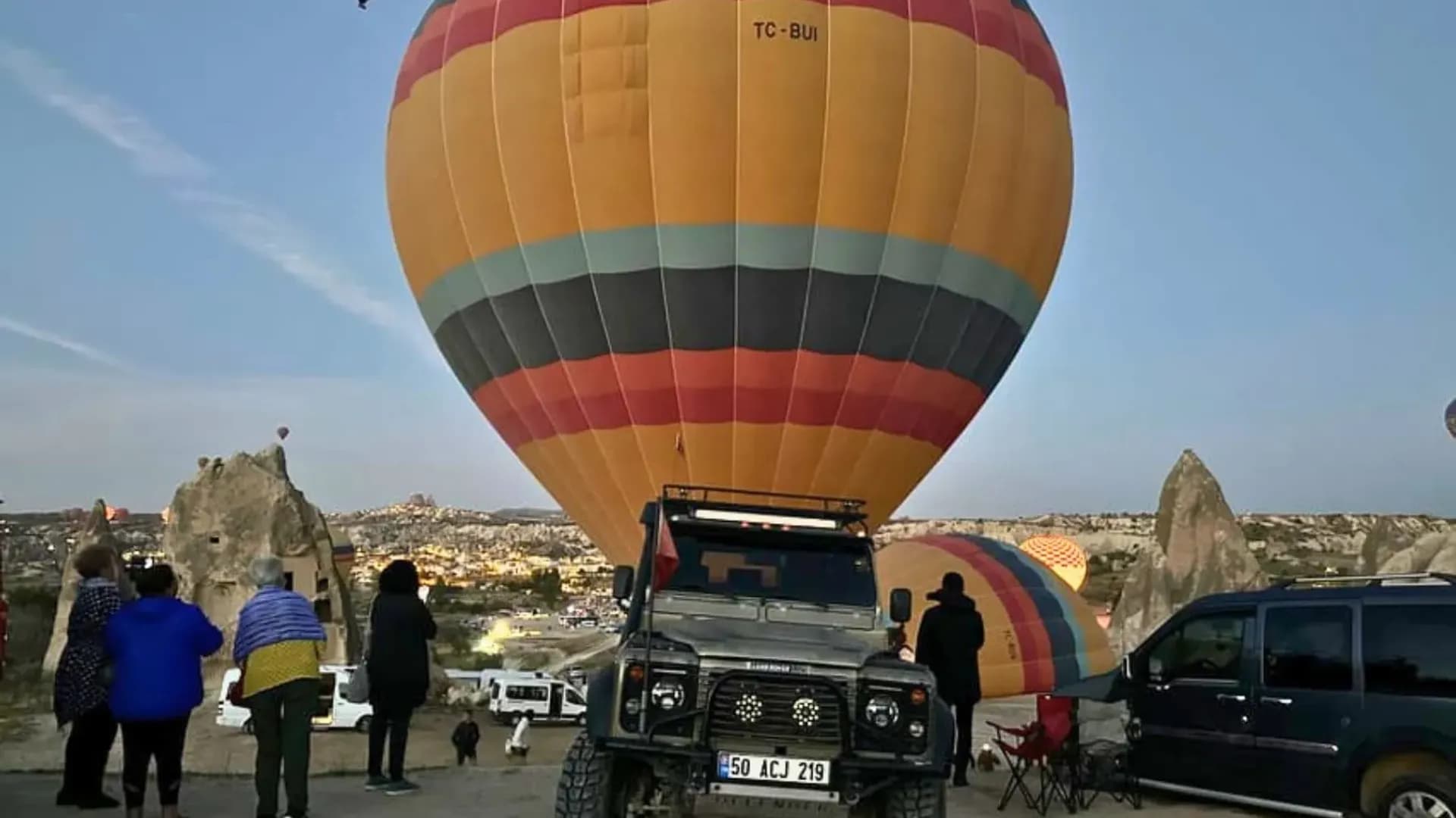 Vehicles beside a hot air balloon
