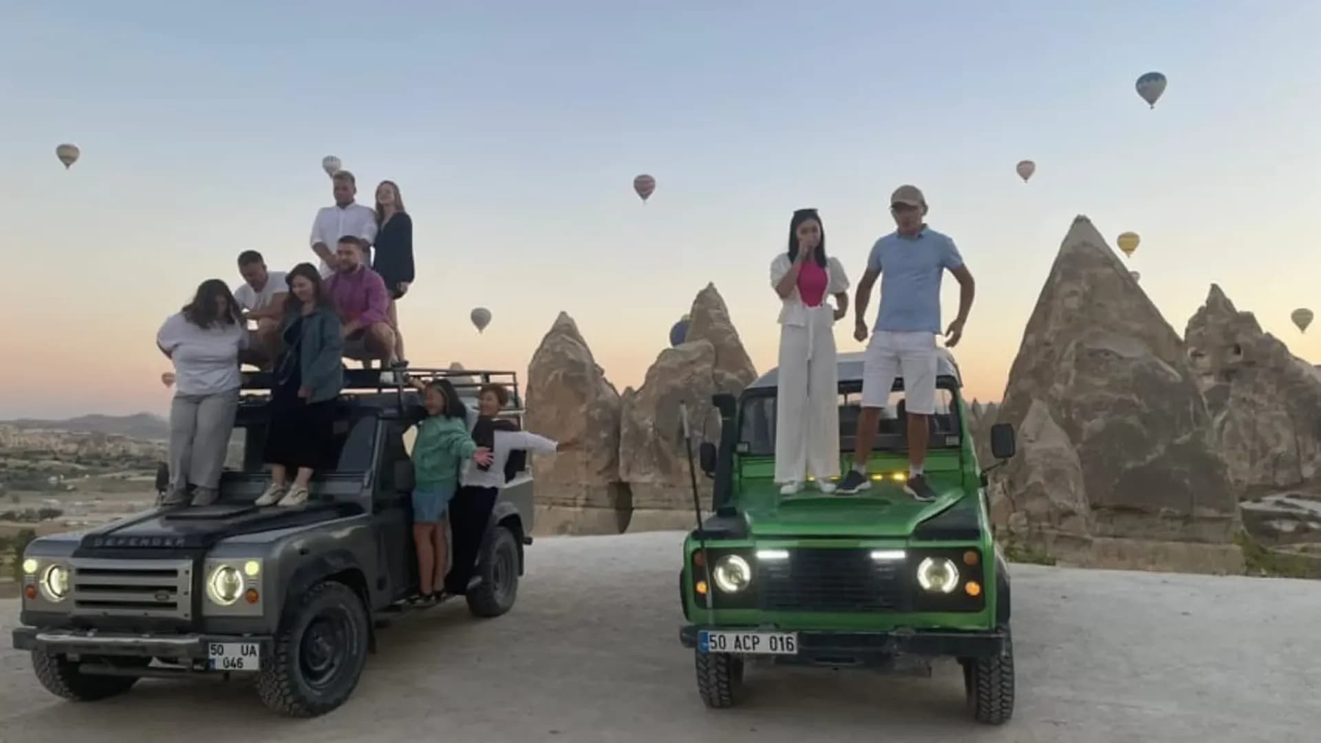 Visitors standing on off-road vehicles
