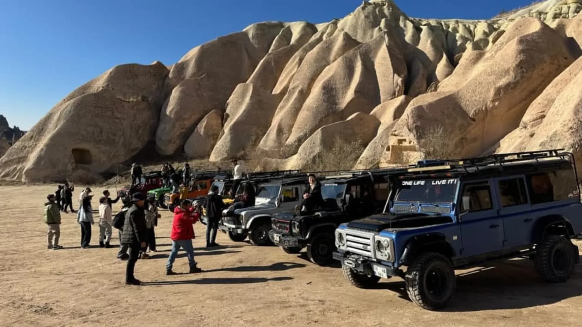 Visitors beside off-road vehicles