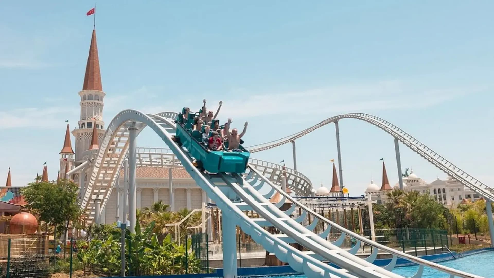 Roller coaster beside a pool