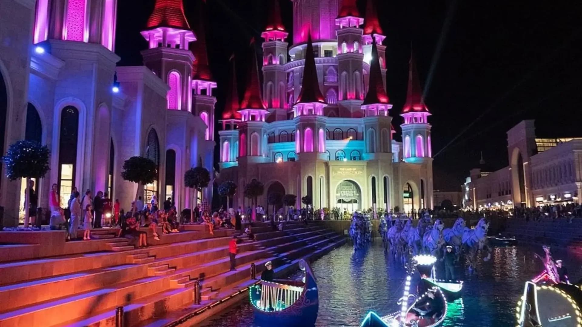 Illuminated theme park buildings at night