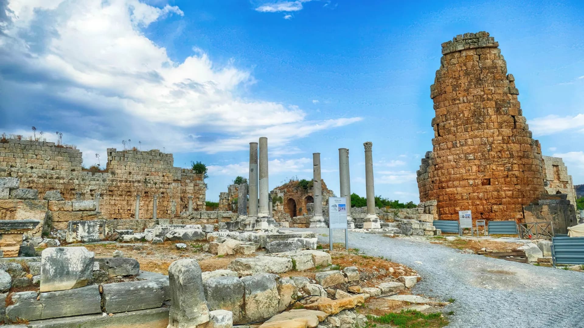 Stone ruins and columns beneath a blue sky