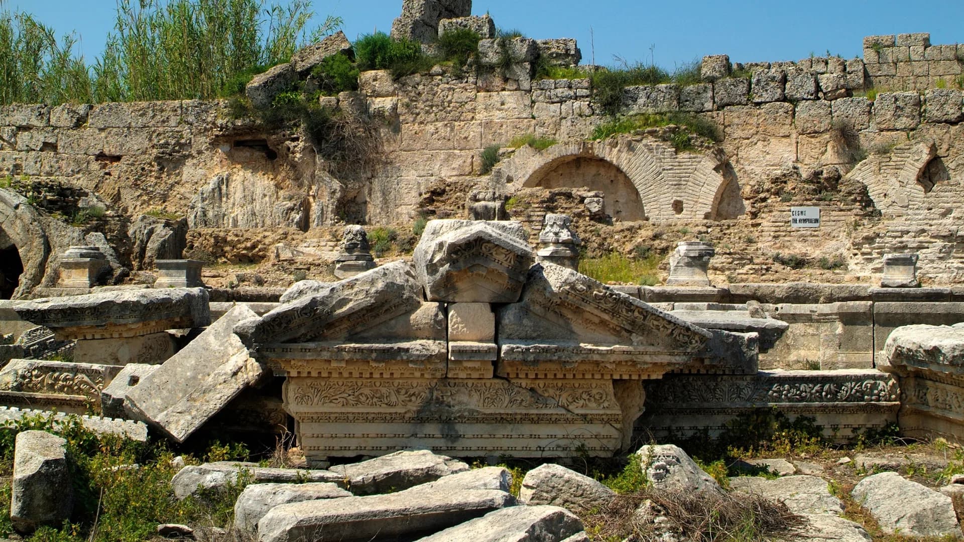 Stone ruins and a carved basin beside an archaeological site