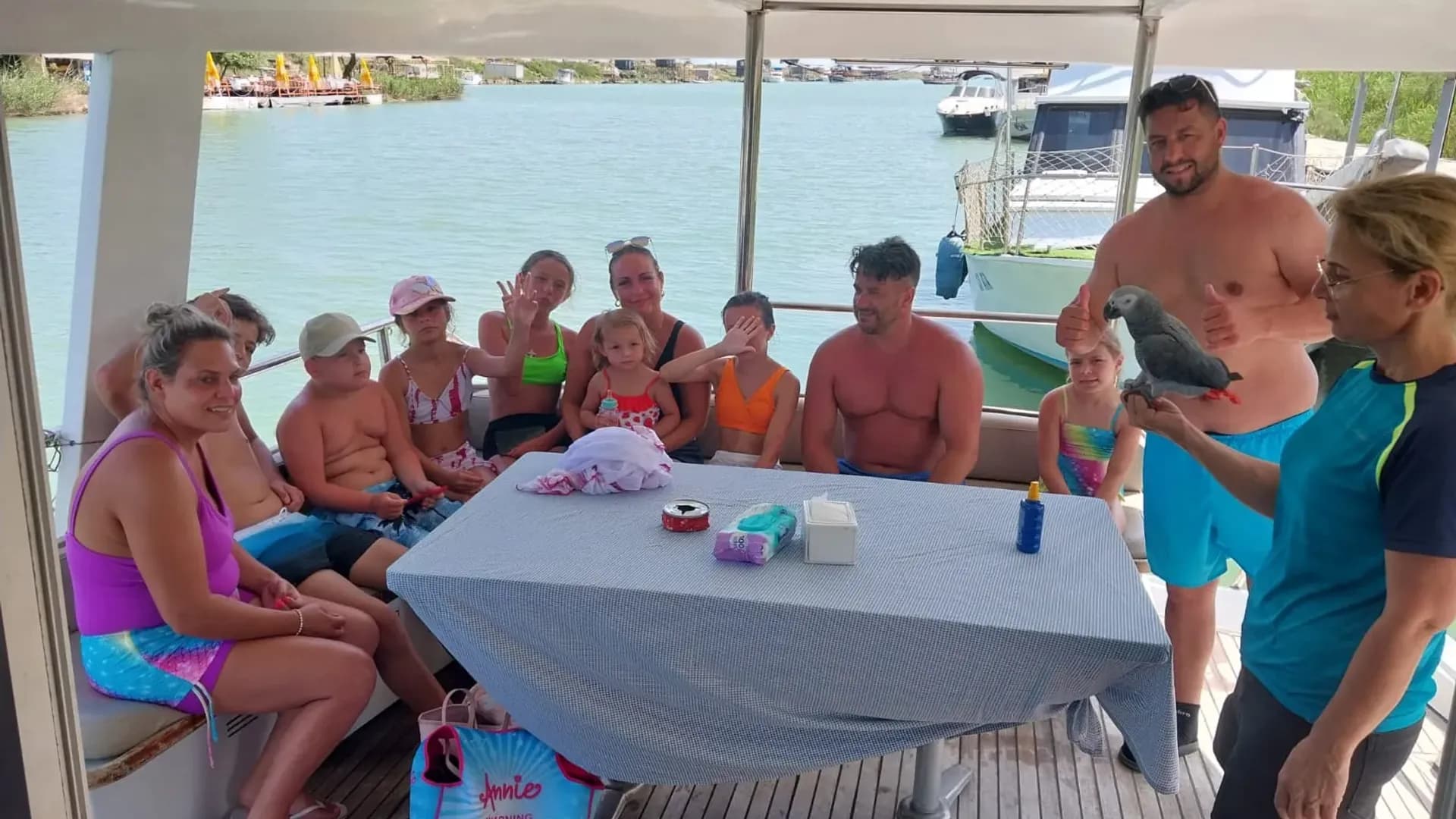 Visitors seated around a table on a boat