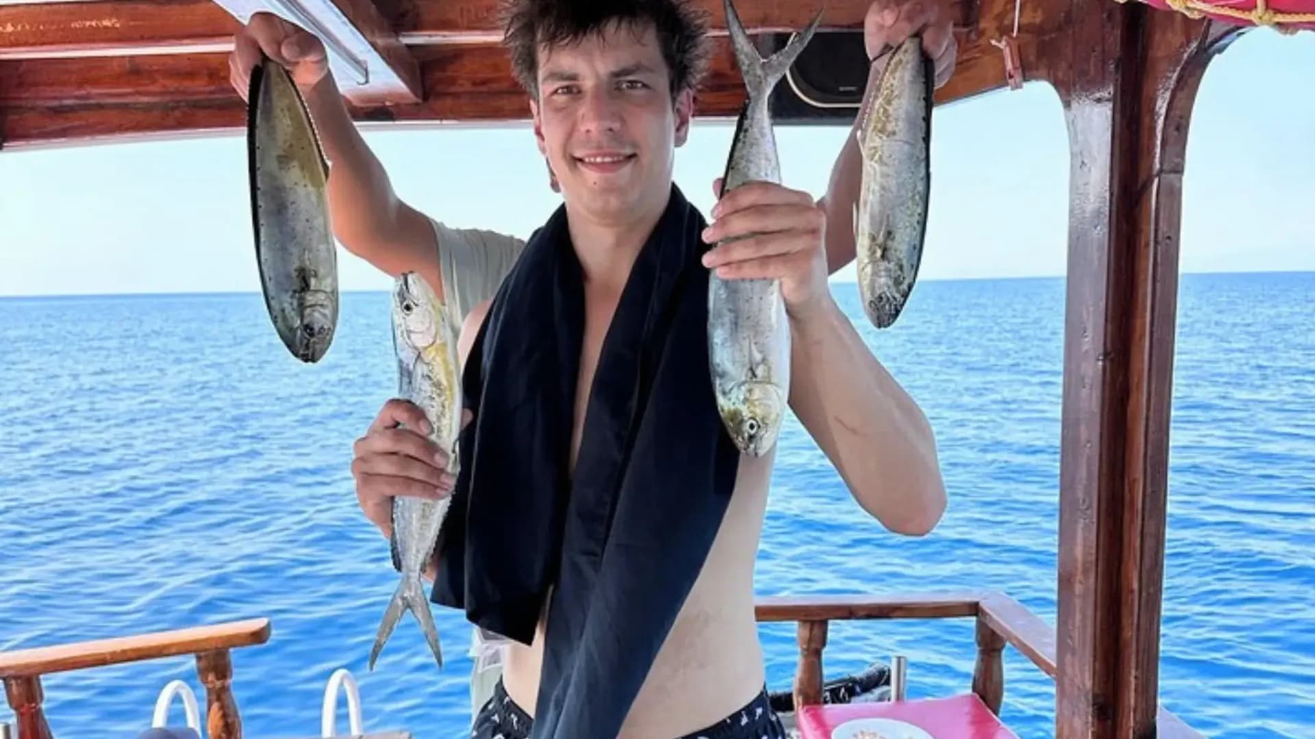 Visitor holding several fish