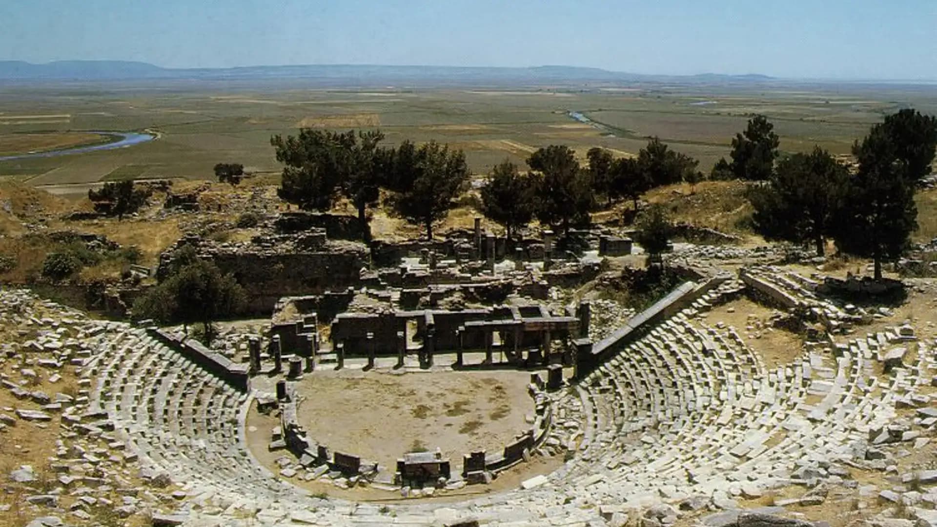 Circular stone theatre in an open landscape