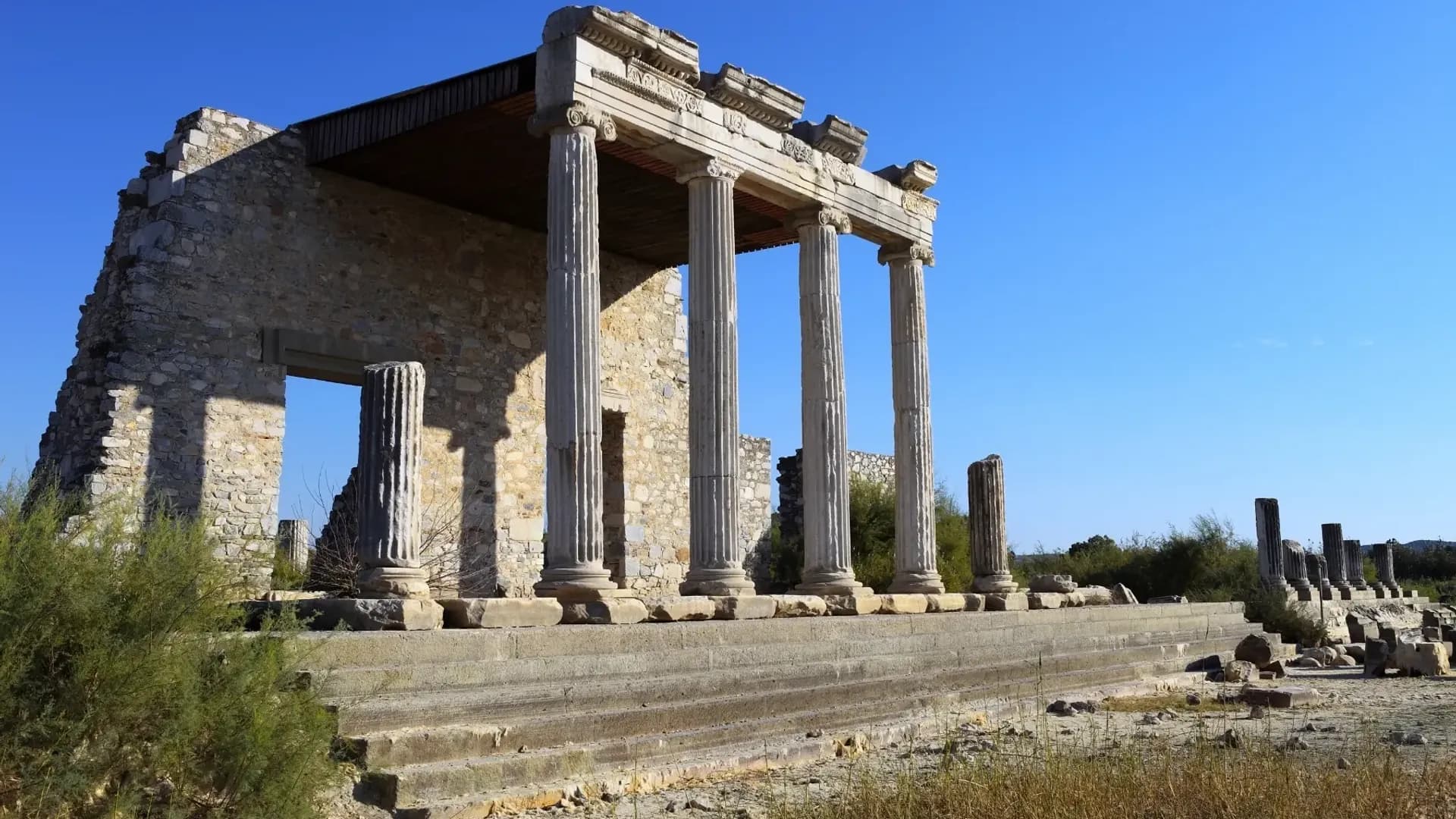 Ancient temple columns beneath a blue sky