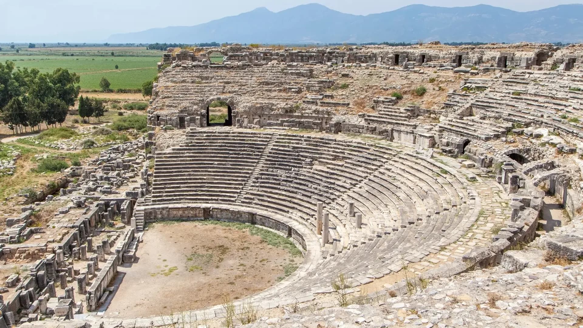 Curved rows of stone seats at an archaeological site