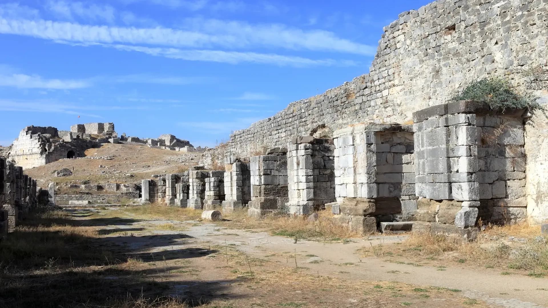 Long stone wall with arched openings