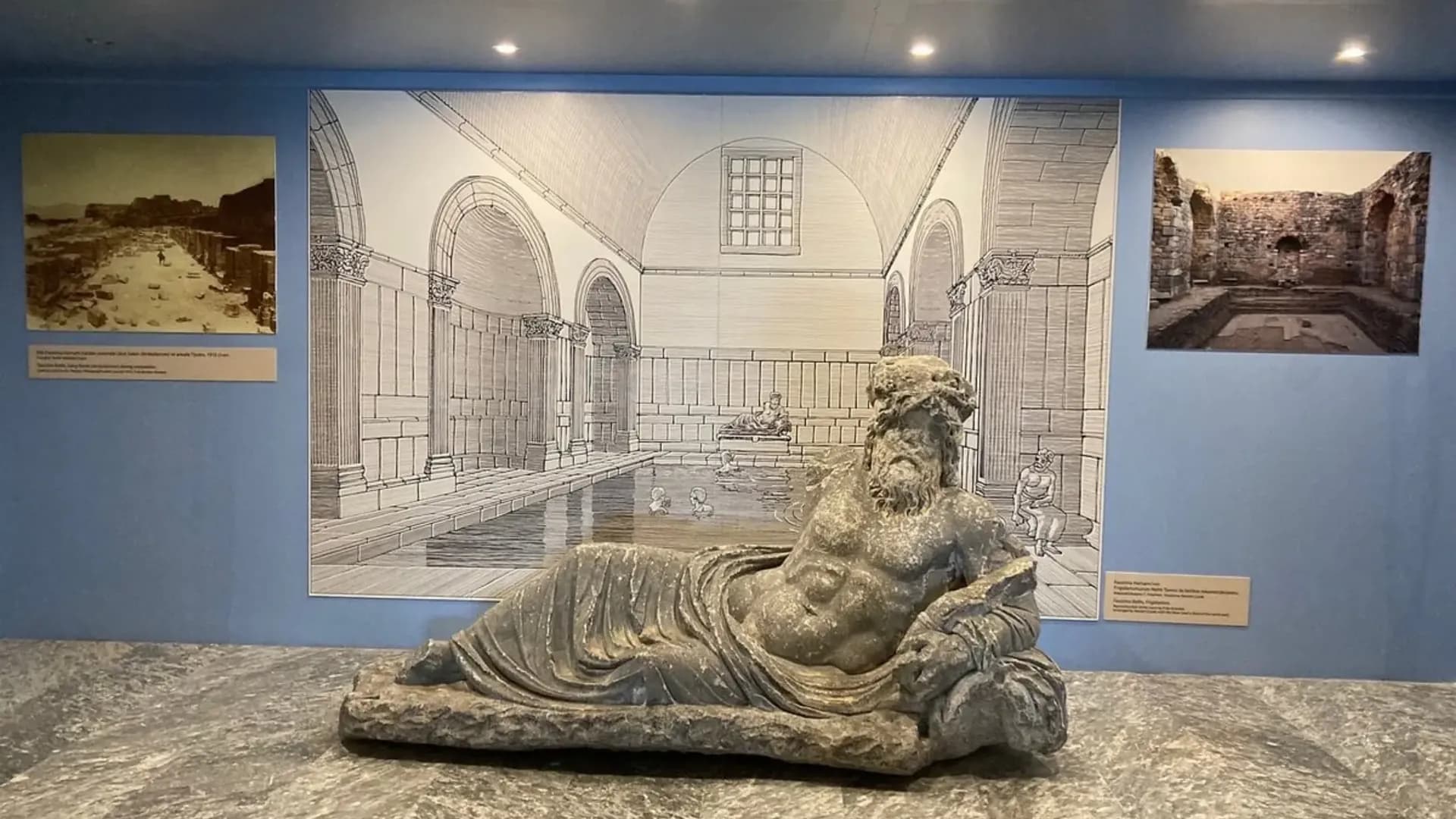 Carved stone figure displayed inside a museum