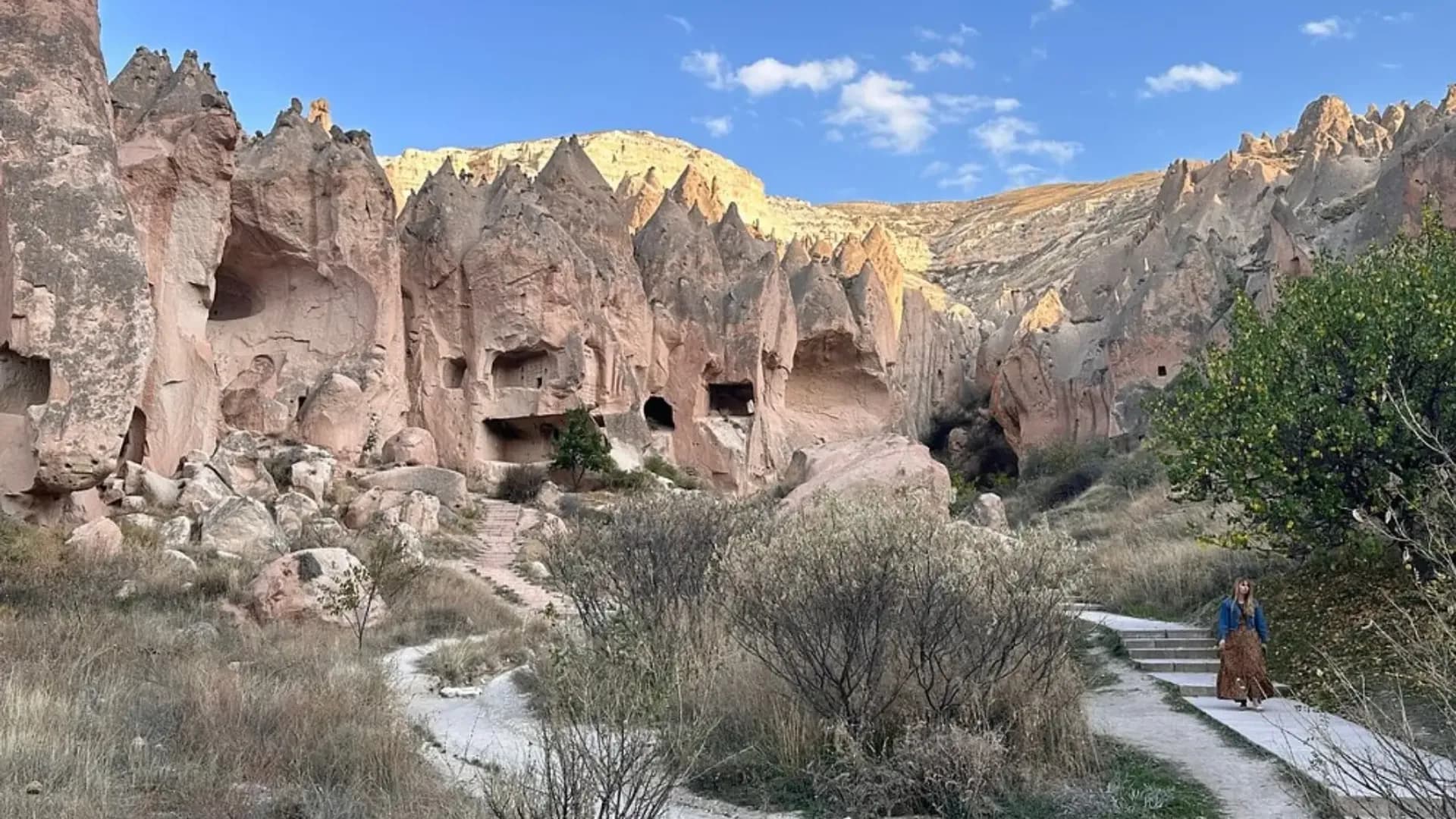In den Fels gehauene Gebäude neben einem Weg durch ein Tal
