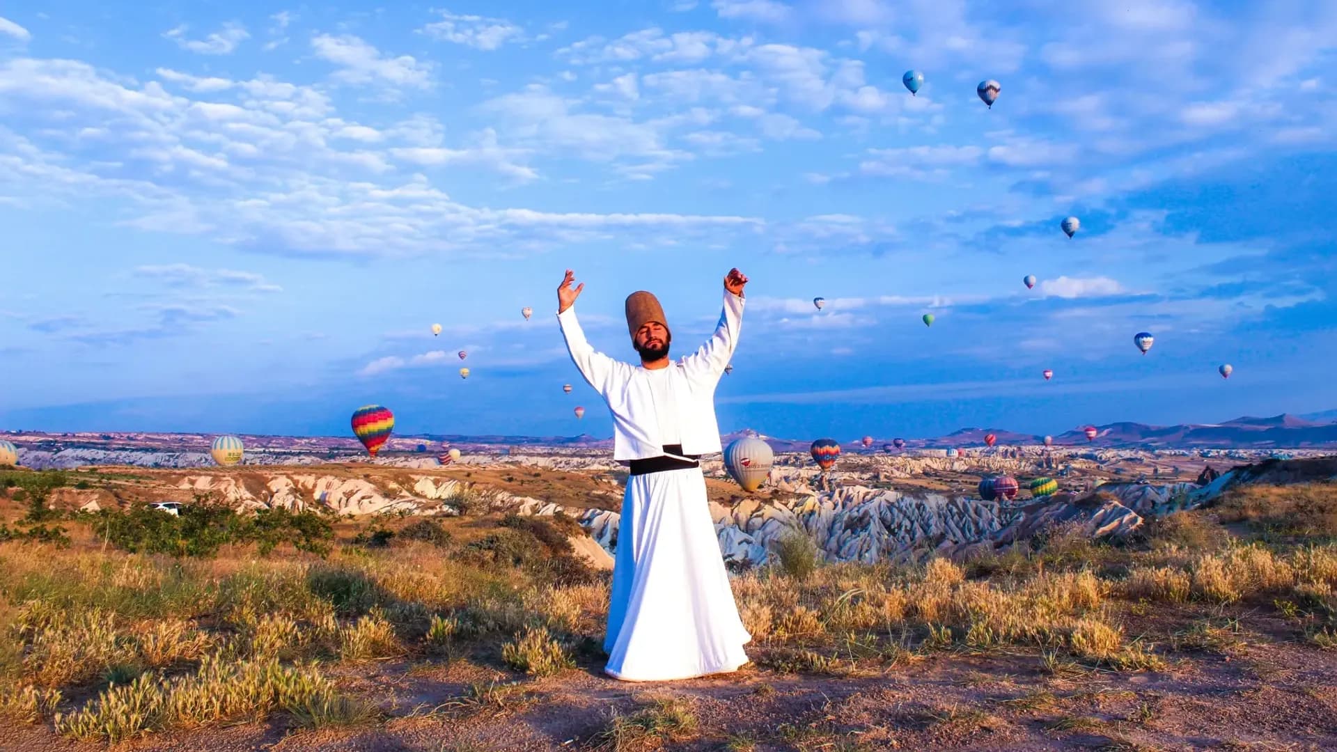 Whirling performer in a rocky landscape
