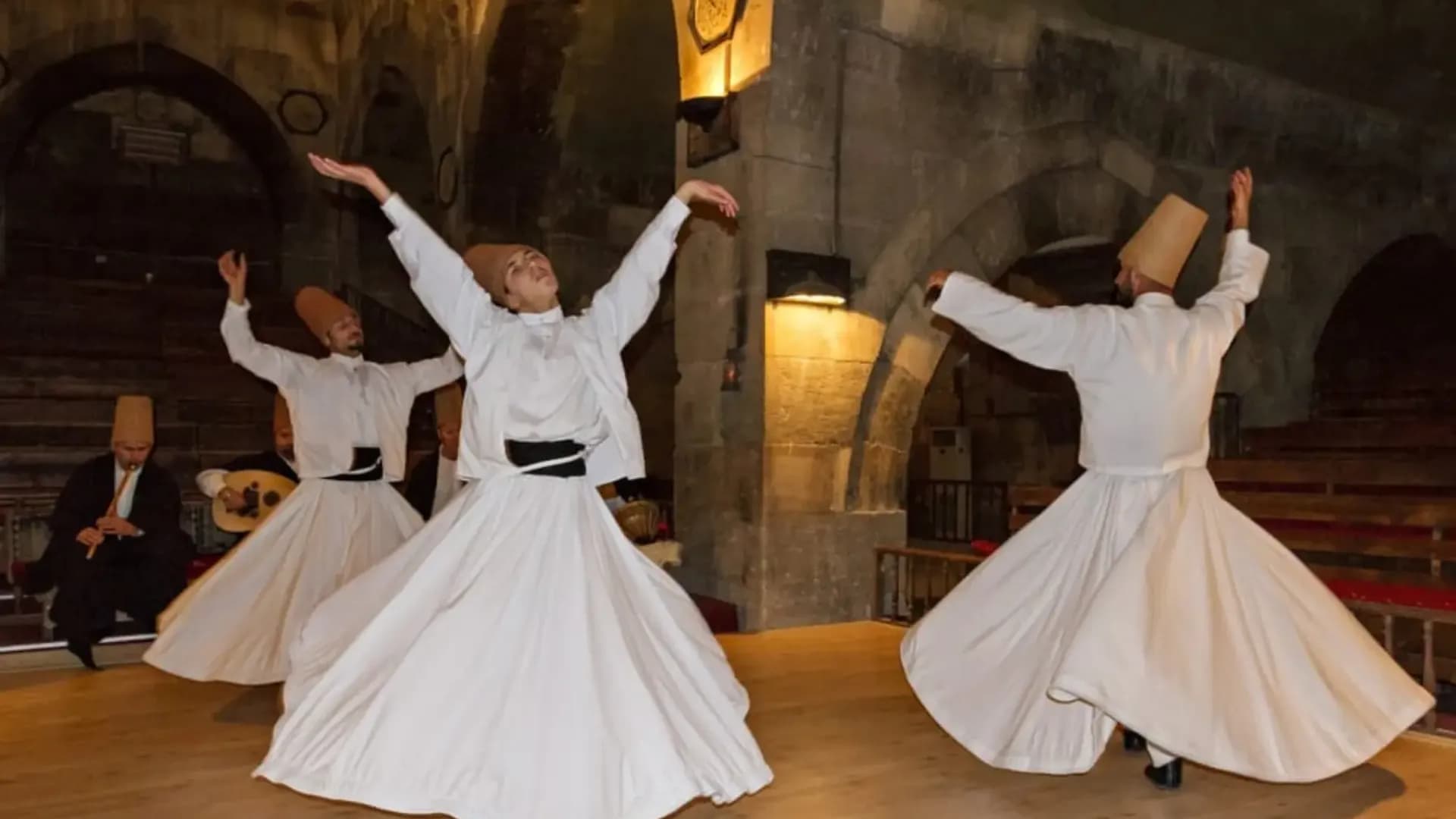 Whirling performers in white robes