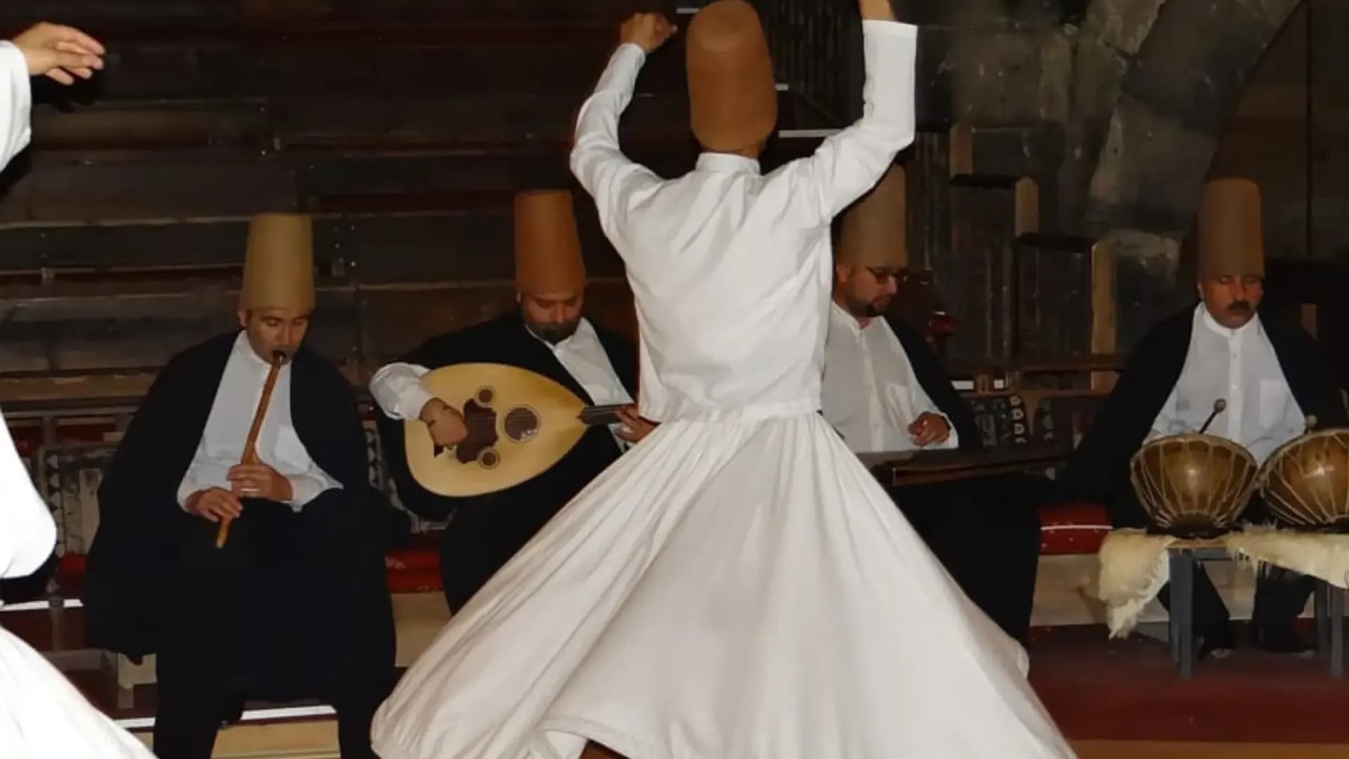 Whirling performer with musicians behind