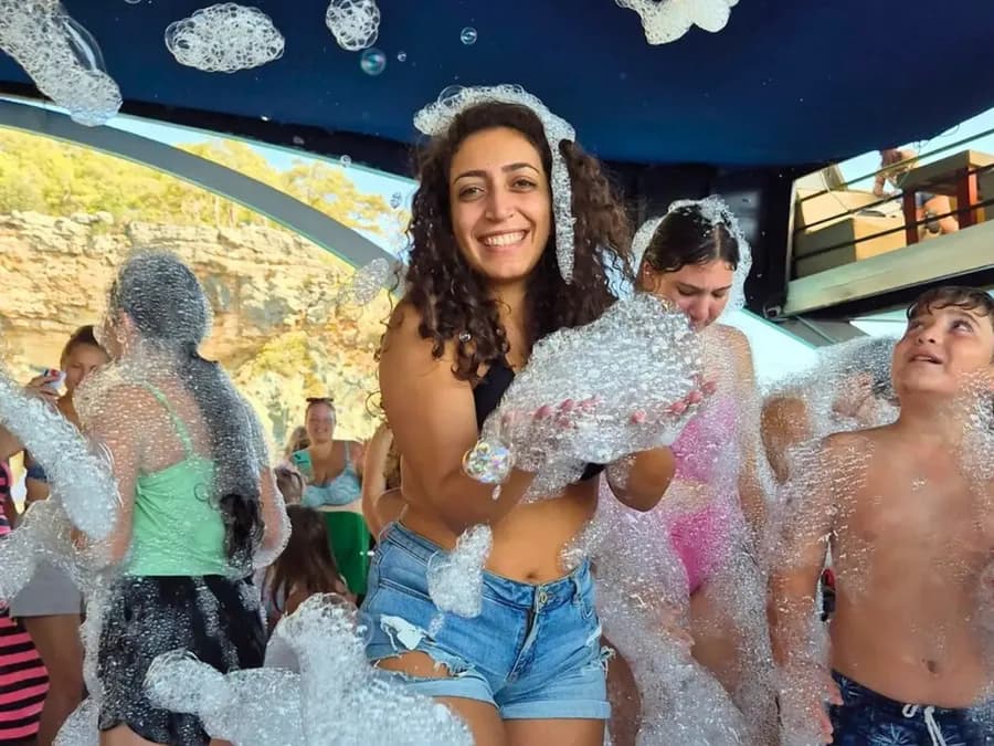 Guests enjoying a foam party on a boat